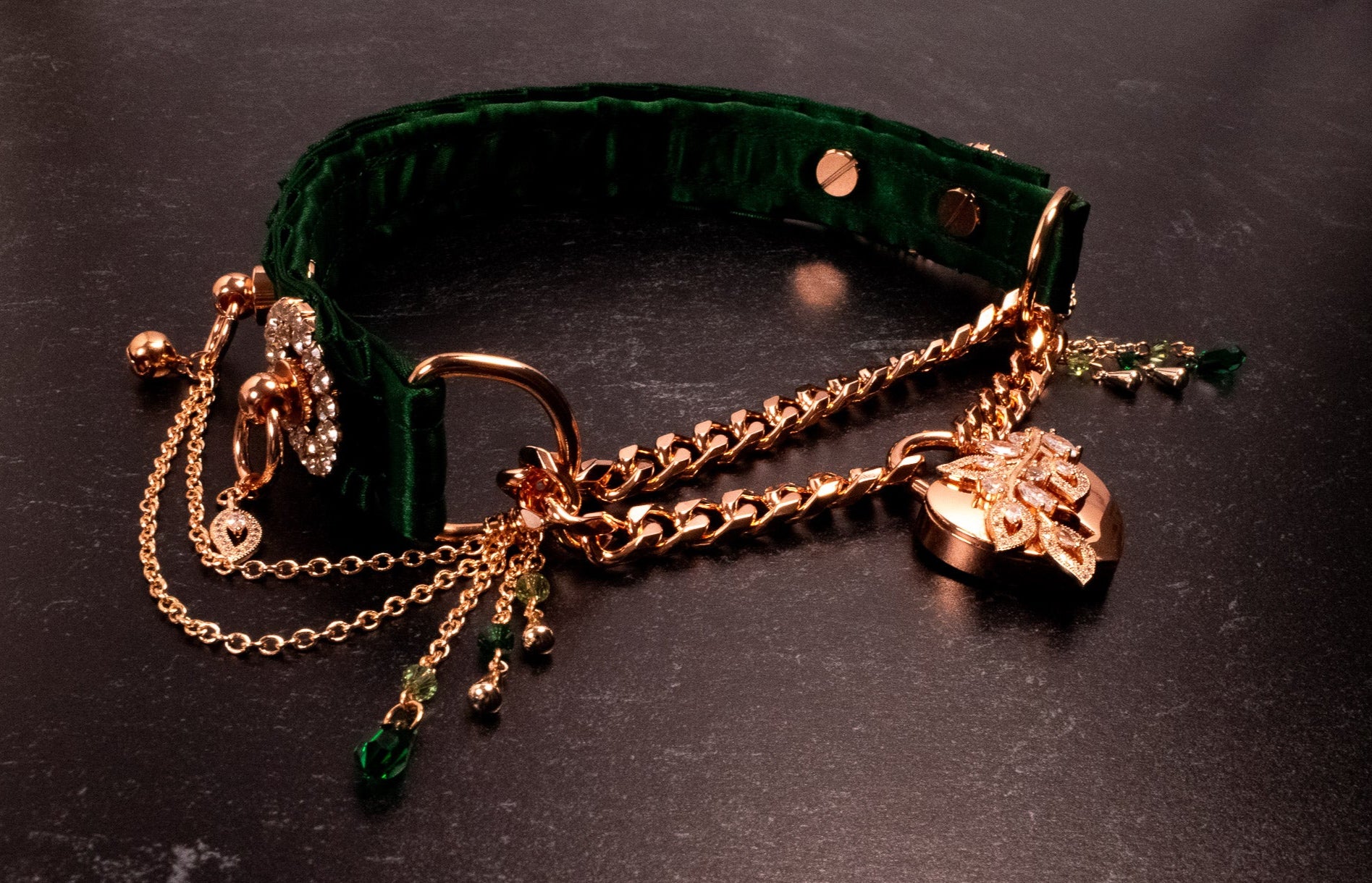 A luxury hunter green velvet martingale collar with rose gold hardware, featuring a high quality curb chain, genuine Preciosa crystals, and a rose gold heart lock with a CZ crystal leaf, accompanied by two keys.