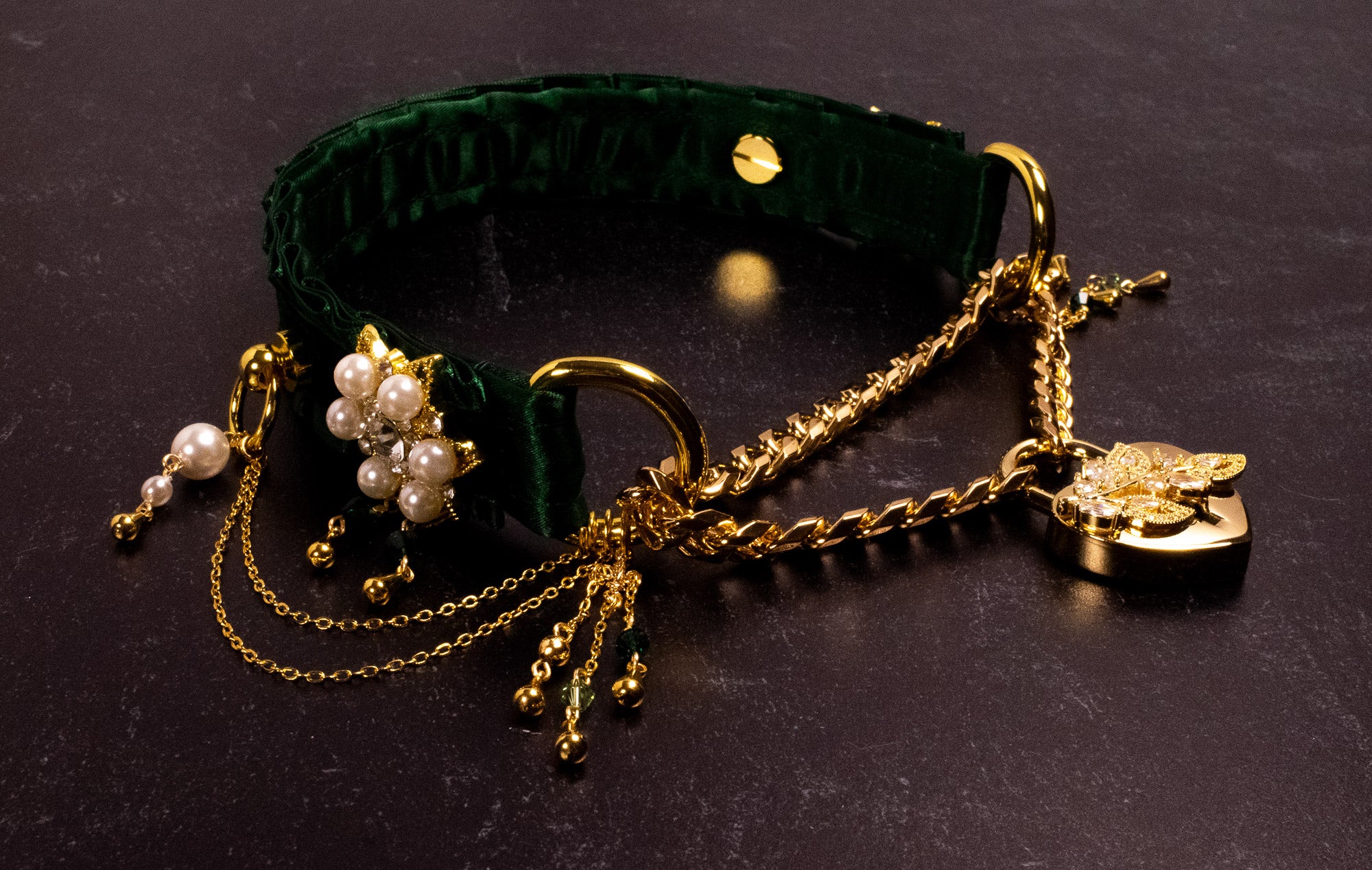 A hunter green velvet luxury locking pearl martingale collar with gold hardware, featuring crystal and pearl encrusted embellishments and a gold heart lock with a CZ crystal leaf. Includes two keys.